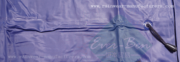 Blue plastic rain mac drawing string on waist